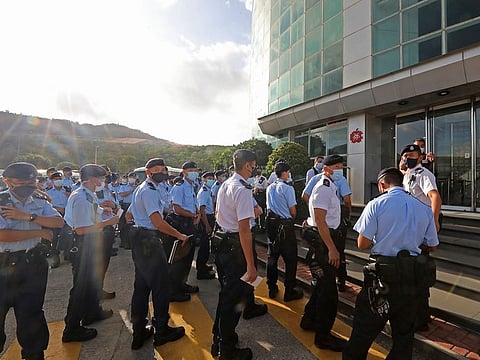 Police officers gather outside the headquarters of Apple Daily in Hong Kong Thursday, June 17, 2021.