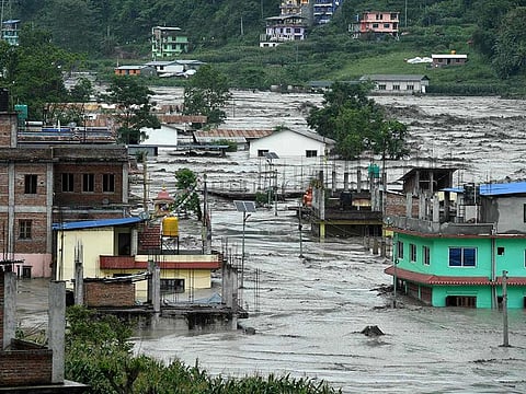 This general view shows houses submerged in flood waters in Sindhupalchok, some 70 km northeast of Kathmandu, after heavy monsoon rains caused the overflowing of the Melamchi River. 