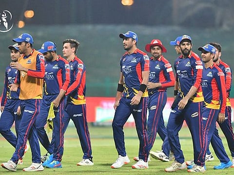 Relieved Karachi Kings players walk back after a 14-run win over Quetta Gladiators, which helped them make the play-offs on better net run-rate on Saturday.