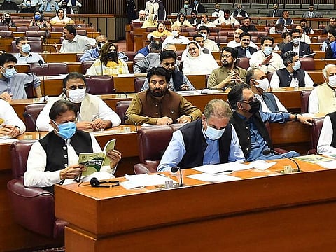File picture: Pakistan Prime Minister Imran Khan (L) attends the session at the National Assembly in Islamabad. 