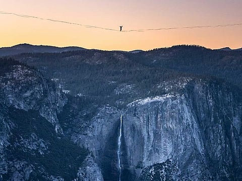 In this Saturday, June 12, 2021, photo provided by Scott Oller Films, highliner Daniel Monterrubio walks the 2,800-foot-long line off Taft Point above Yosemite Valley in Yosemite, California. 
