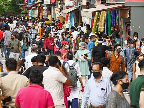 People throng Sarojini Nagar market for shopping after authorities eased a lockdown imposed, in New Delhi on June 19, 2021. 