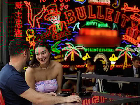 Kat Orozco spends a light moment with Mark Aviv, during lunch at the Grand Central Market on the first day that California reopened its economy in downtown Los Angeles on June 15, 2021.