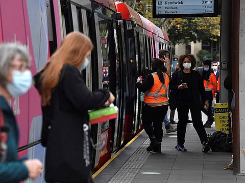 Passengers wearing face masks alight from a metro in Sydney on June 23, 2021, as residents were largely banned from leaving the city to stop a growing outbreak of the highly contagious Delta COVID-19 variant spreading to other regions.