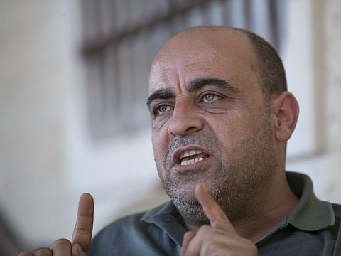 Nizar Banat, an outspoken of the Palestinian Authority, speaks to journalists at the family house, in the West Bank city of Hebron, on May 4, 2021.