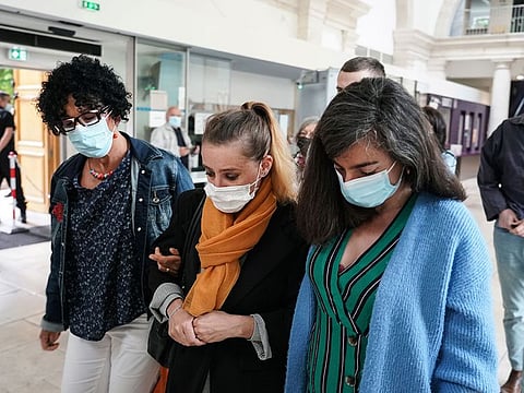 Valerie Bacot, center, arrives with relatives at the Chalon-sur-Saone courthouse, central France.