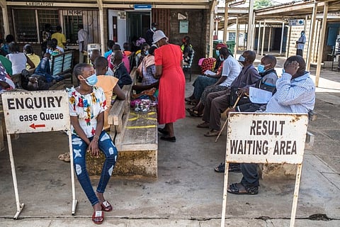 People await laboratory results at the Jaramogi Oginga Odinga Teaching and Referral Hospital in Kisumu County, Kenya on June 14, 2021. The pandemic is worsening in Africa as more contagious variants spread, vaccinations lag and hospitals in some places are pushed beyond their limits.  