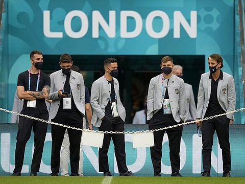 Italy's manager Roberto Mancini (right) and players arrive for a walk around at Wembley stadium in London. They play Austria in the Euro 2020 championship round of 16 match tonight.