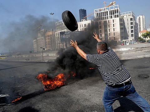 Demonstrators burn tires to block the Martyrs' Square in the centre of Lebanon's capital Beirut on June 26, 2021, as they protest against dire living conditions amidst the ongoing economical and political crisis. 