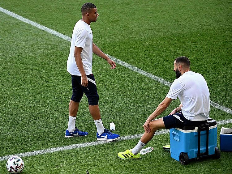 France strikers Kylian Mbappe and Karim Benzema take a break during training