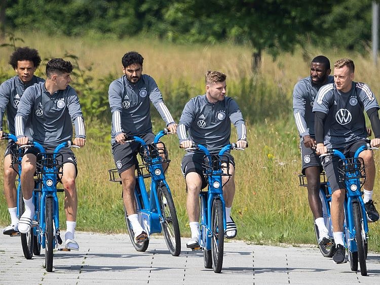 Germany's Leroy Sane, Kai Havertz, Ilkay Guendogan, Timo Werner, Antonio Ruediger and goalkeeper Bernd Leno ride their bikes during a training session 