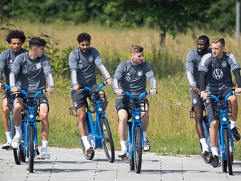 Germany's Leroy Sane, Kai Havertz, Ilkay Guendogan, Timo Werner, Antonio Ruediger and goalkeeper Bernd Leno ride their bikes during a training session 
