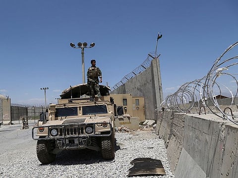 An Afghan National Army (ANA) soldier looks out while standing on a Humvee vehicle at Bagram Air Base, after all US and Nato troops left, some 70km north of Kabul on July 2, 2021. 