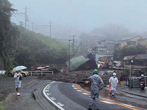 In this photo taken and provided by Satoru Watanabe, a road is covered by mud and debris following heavy rain in Atami city, Shizuoka prefecture, Saturday, July 3, 2021. 