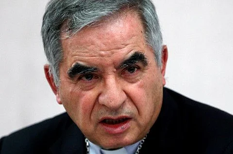 Cardinal Giovanni Angelo Becciu, who has been caught up in a real estate scandal, speaks to the media a day after he resigned suddenly and gave up his right to take part in an eventual conclave to elect a pope, near the Vatican, in Rome, on September 25, 2020. 