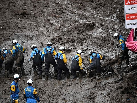 Police search for missing people buried under mud at the scene of a landslide following days of heavy rain in Atami in Shizuoka Prefecture on July 5, 2021.