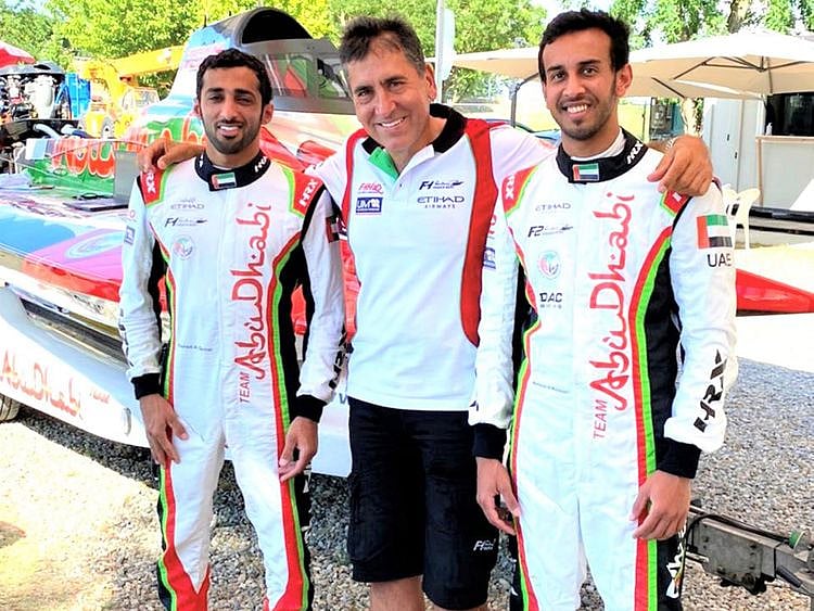 Team Abu Dhabi's Rashed Al Qemzi and Mansoor Al Mansoori with team manager Guido Cappellini.