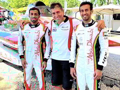 Team Abu Dhabi's Rashed Al Qemzi and Mansoor Al Mansoori with team manager Guido Cappellini.