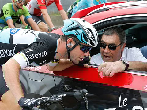 Mark Cavendish is all ears to British sprinter equal Eddy Merckx (right) before starting a stage in Tour de France in 2015. Cavendish equalled his record of 34 stage wins in Tour de France on Friday.