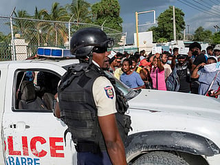 Haitian National Policemen guard the entrance to the US Embassy  