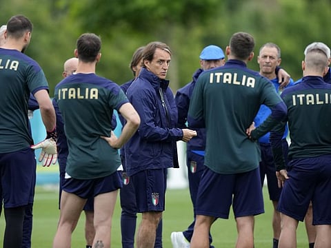 Italy's manager Roberto Mancini speaks to his players during a training session at Tottenham Hotspur training ground in London ahead of the Euro 2020 championship final against England at Wembley Stadium tonight.