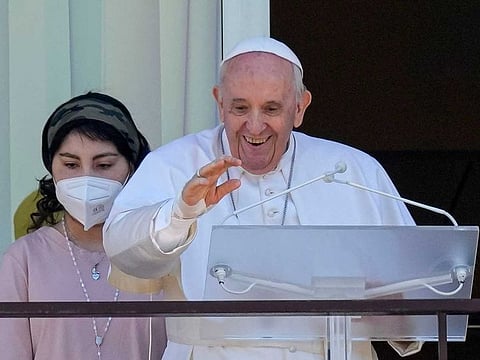 Pope Francis appears with young oncologic patients on a balcony of the Agostino Gemelli Polyclinic in Rome, Sunday, July 11, 2021, where he is recovering from intestinal surgery, for the traditional Sunday blessing and Angelus prayer. Pope Francis is 84 and had a part of his colon removed a week ago. 
