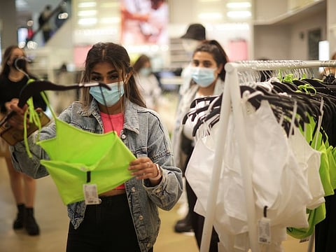 People shop in a store  in London on July 6, 2021.  