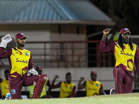 Chris Gayle (right) and Nicholas Pooran, stand-in captain of the West Indies, take the knee as an anti-racism gesture on the eve of their T20 series against Australia at St. Lucia on Monday.