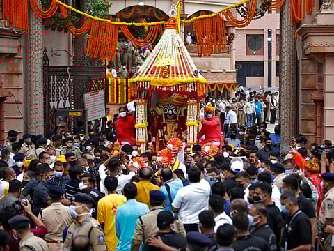 Hindu devotees pull a "Rath" or a chariot of Lord Jagannath, outside a temple during the annual Rath Yatra, or chariot procession, in Ahmedabad on July 12, 2021. 