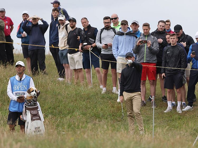 Fans watch Rory McIlroy during a practice round for the Open at Royal St George's 