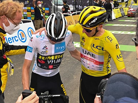 Slovenia's Tadej Pogacar, wearing the overall leader's yellow jersey, and Denmark's Jonas Vingegaard, wearing the best young rider's white jersey, after the 18th stage of the Tour de France race on Thursday. 