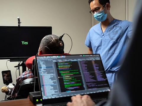 Dr. Eddie Chang, a neurosurgeon at the University of California, San Francisco Medical School, helps Pancho, a man paralysed since age 20, speak through an implant in his brain that connects to a computer program in San Francisco on July 5, 2021. In a once unimagined accomplishment, electrodes implanted in the man’s brain transmit signals to a computer that displays his words. 