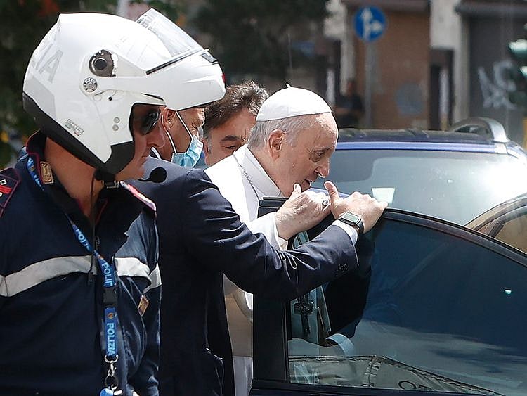 In this frame taken from video, Pope Francis stops to greet the police that escorted him before entering the Vatican after leaving the hospital 10 days after undergoing planned surgery to remove half his colon on July 14, 2021. 