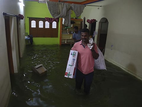 People shift their belongings to safer areas after their house got flooded following heavy rainfall at Meerpet-Jillelguda in Hyderabad, on July 16.