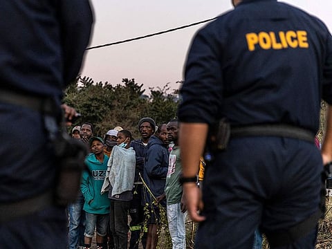Police officers argue with members of the community.