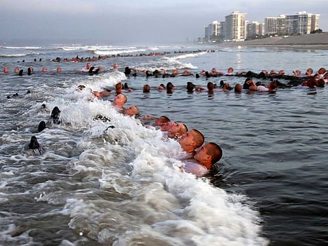 A photo provided by the US Navy shows SEAL candidates during surf immersion training in Coronado, Calif., on May 4, 2020. A woman has joined a US Navy special warfare unit for the first time, the latest gender barrier to fall in the five years since women became eligible to apply for any combat job in the military. 