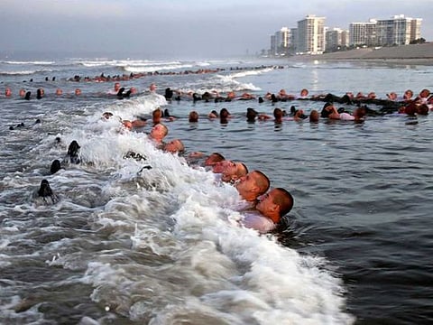 A photo provided by the US Navy shows SEAL candidates during surf immersion training in Coronado, Calif., on May 4, 2020. A woman has joined a US Navy special warfare unit for the first time, the latest gender barrier to fall in the five years since women became eligible to apply for any combat job in the military. 