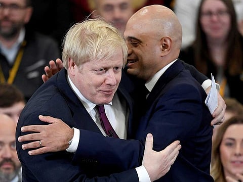 Britain's Prime Minister Boris Johnson is embraced by Britain's Chancellor of the Exchequer Sajid Javid before speaking to the workers as he visits a JCB factory during his general election campaign in Uttoxeter, Britain, December 10, 2019.  Boris Johnson has been identified by the country’s test-and-trace system as a contact of a confirmed coronavirus case, Health Secretary Sajid Javid. 