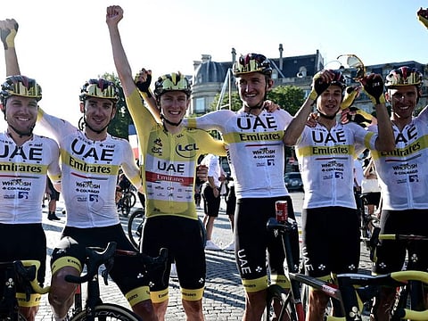 Winner team UAE Emirates' Tadej Pogacar (centre) of Slovenia wearing the overall leader's yellow jersey celebrates with his teammates at the end of the 21th and last stage of the 108th edition of the Tour de France cycling race, 108 km between Chatou and Paris Champs-Elysees.