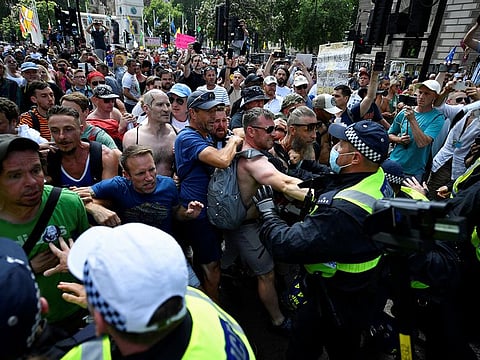 Protesters scuffle with police during "Freedom day" demonstration, on the day when most coronavirus disease (COVID-19) restrictions are lifted, in London, Britain July 19, 2021.