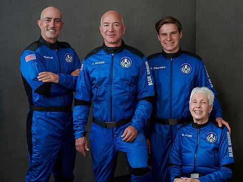 Billionaire Jeff Bezos, founder of ecommerce company Amazon.com Inc, his brother Mark Bezos, a private equity executive, pioneering female aviator Wally Funk and recent Dutch high school graduate Oliver Daemen pose in an undated photograph, ahead of their scheduled flight aboard Blue Origin's New Shepard rocket near Van Horn, Texas, U.S.
