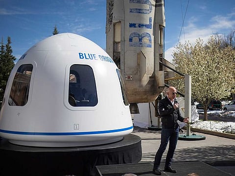 Jeff Bezos in front of Blue Origin's New Shepard system during the Space Symposium in Colorado Springs, Colo., April 5, 2017. 
