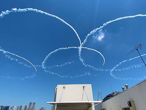 Japan's Air Self Defense Force (JASDF) aerobatics team, the Blue Impulse, skywrite Olympic rings in a practice run ahead of the official opening of the Tokyo 2020 Olympic Games in Japan on Wednesday.