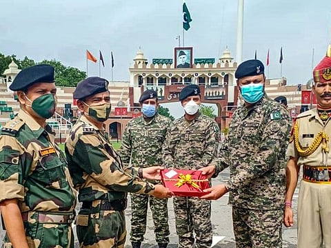 Indian and Pakistan forces exchange sweets on the occasion of Eid Al Adha at Attari Wagha Border, on July 21, 2021.  
