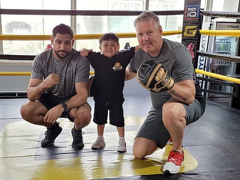 Abdu Rozik with boxing star Amir Khan (left) and coach Tony Davis. 