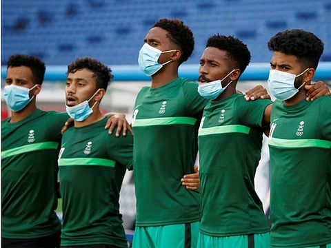 Saudi Arabia players line up for the national anthems before their Group D match against Ivory Coast at the International Stadium Yokohama, Yokohama, Japan.