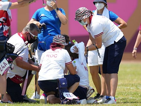 Svetlana Gomboeva is treated for heat exhaustion after completion of the archery ranking round during the Tokyo 2020 Olympic Summer Games at Yumenoshima Archery Field.