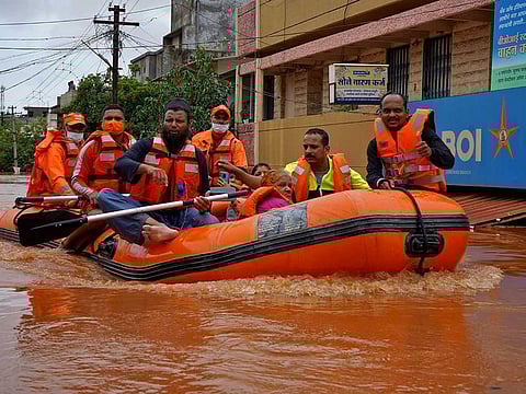 Members of National Disaster Response Force (NDRF) evacuate people from a flooded area to safer places in Kolhapur in the western state of Maharashtra, India, July 24, 2021. 