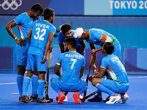 India captain Manpreet Singh (7) in a huddle with his teammates after conceding the sixth goal against Team Australia during their men's field hockey Group A match at the Tokyo Olympics on Sunday.