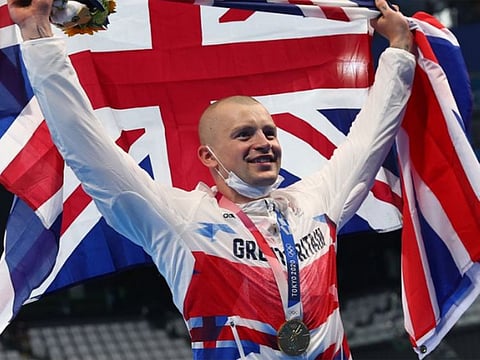Adam Peaty of Great Britain poses with the gold medal after winning the 100m breaststroke.